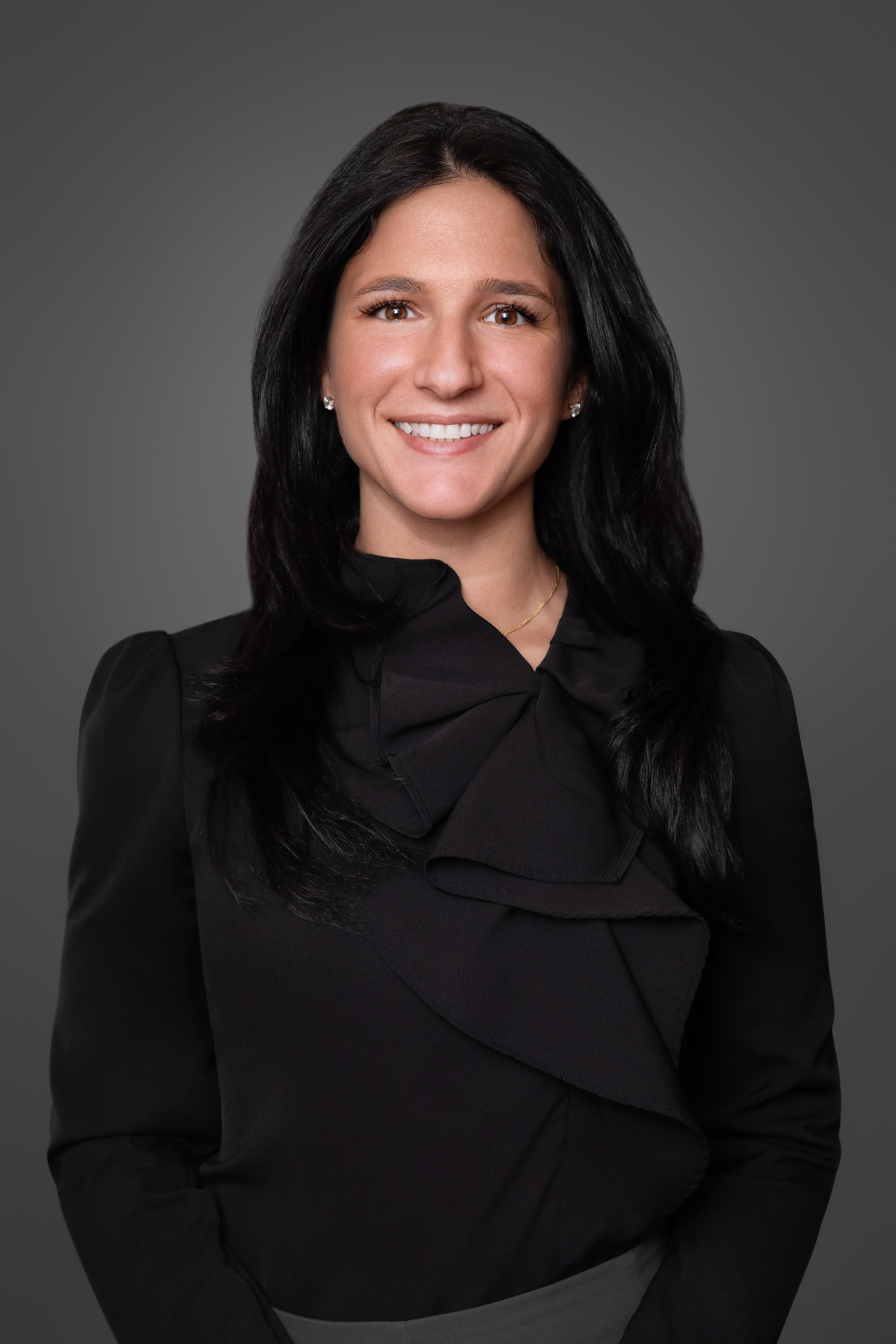 Melissa Varela Vargas, Billing & Account Receivable Coordinator at Maryam Jahedi Law Firm P.C., smiling in a professional setting, wearing a pink top, against a dark background, emphasizing her role in client account management and support.