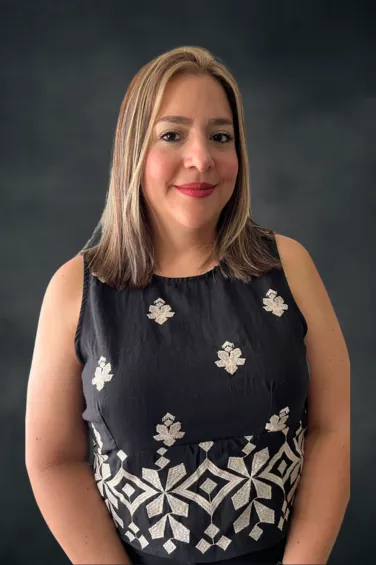 Catalina Bolanos, Billing & Account Receivable Coordinator at Maryam Jahedi Law Firm, smiling in a leopard print blouse against a dark background.