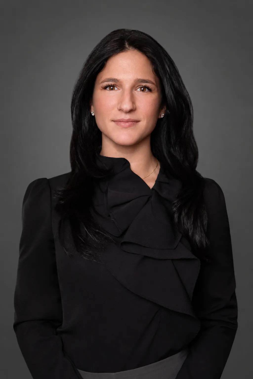 Melissa Varela Vargas, Billing & Account Receivable Coordinator at Maryam Jahedi Law Firm P.C., smiling in a professional setting, wearing a pink top, against a dark background, emphasizing her role in client account management and support.