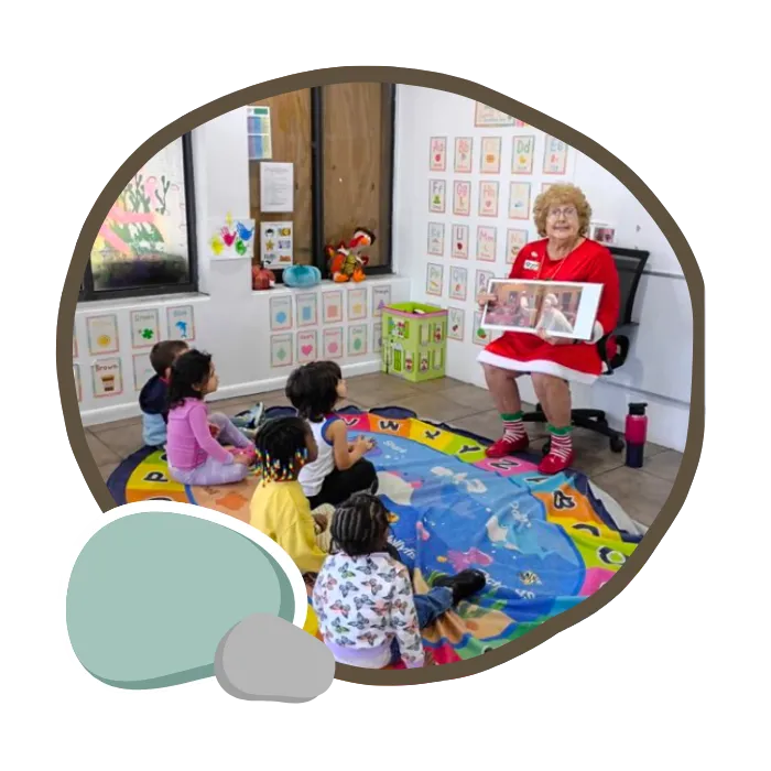 Teacher helping preschoolersat Pebblestone Academy