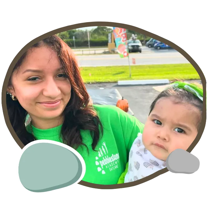 Staff member holding baby at Pebblestone Academy