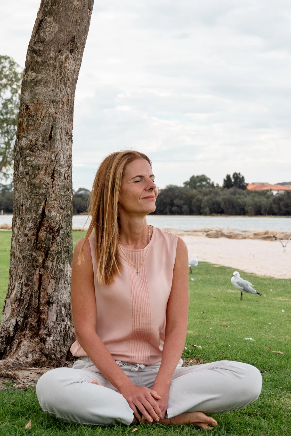 Jelena Ilic sitting under a tree by the river
