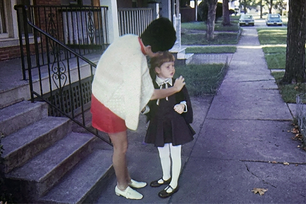 Woman and child standing on sidewalk