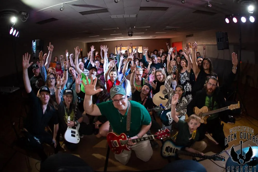 man playing black electric guitar