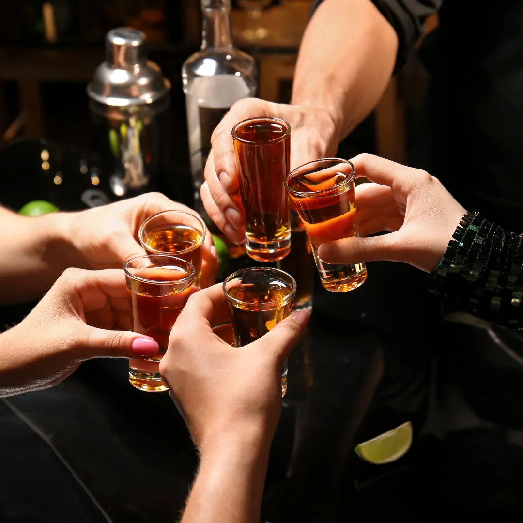hands holding beer sample glasses and holding them up to cheers