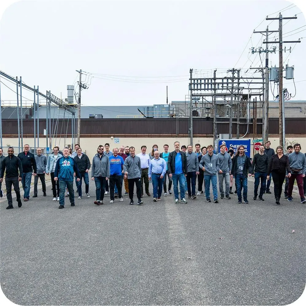 Small business owner handing keys to employees to symbolize succession