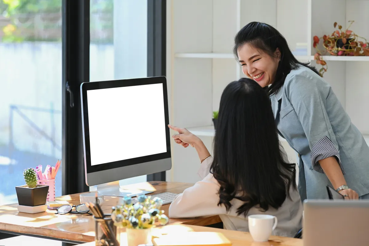 women working together on a computer
