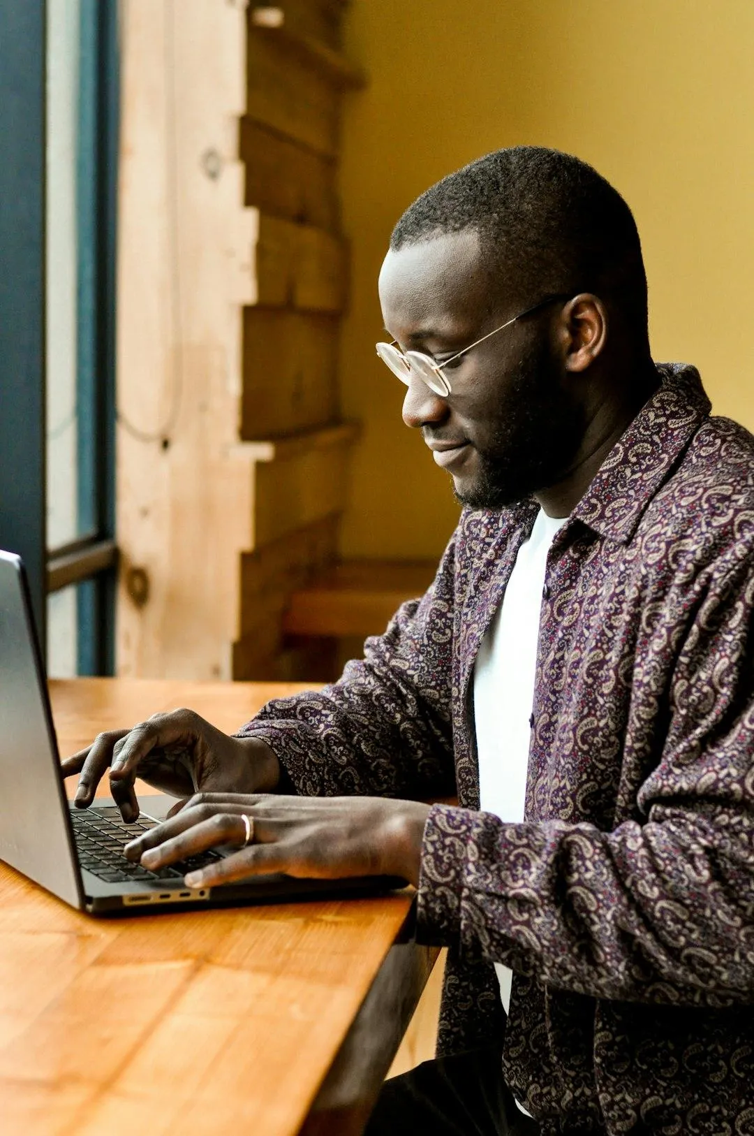 Small business owner reviewing marketing audit results on laptop at cafe