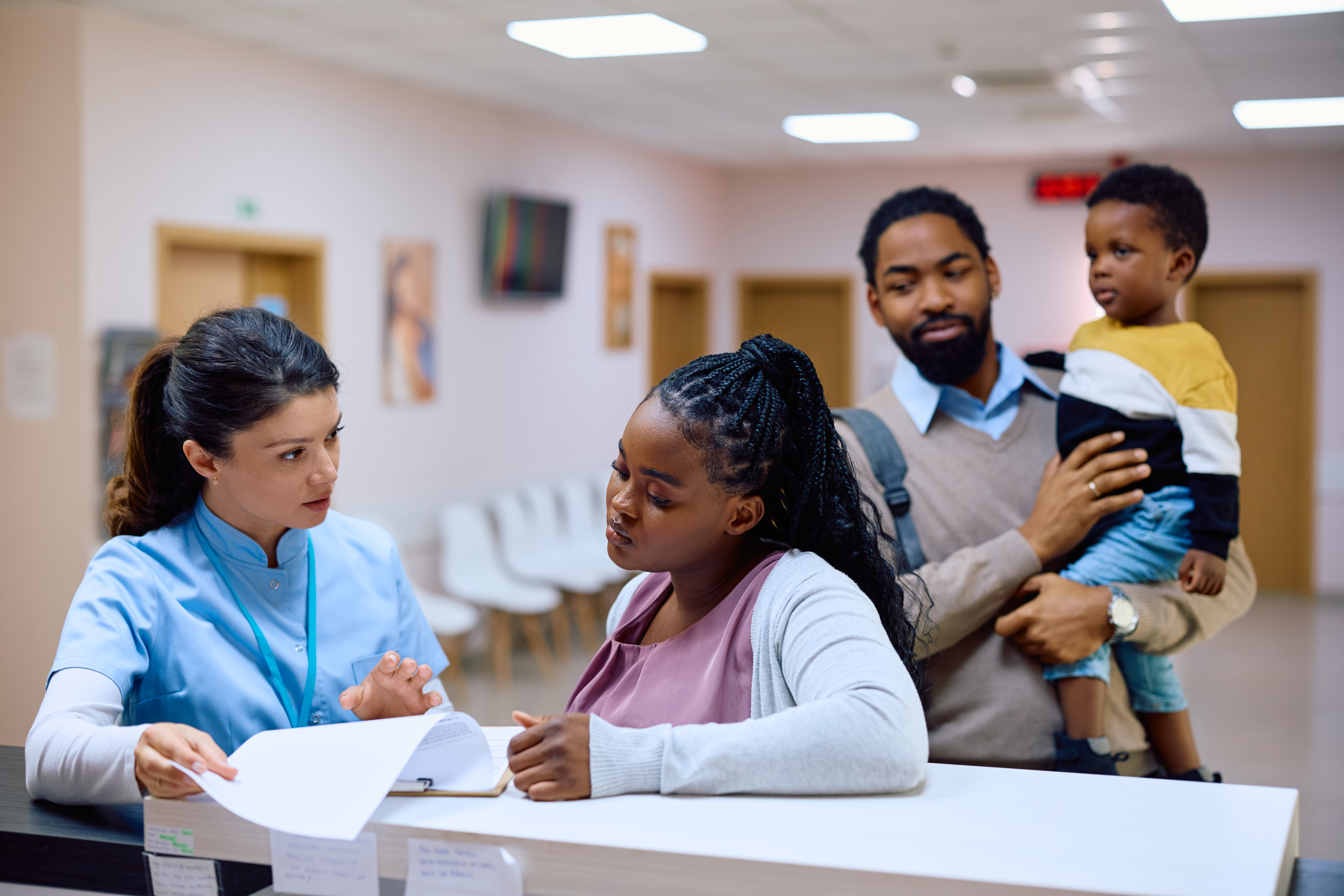 selective focus photography of woman holding yellow petaled flowers