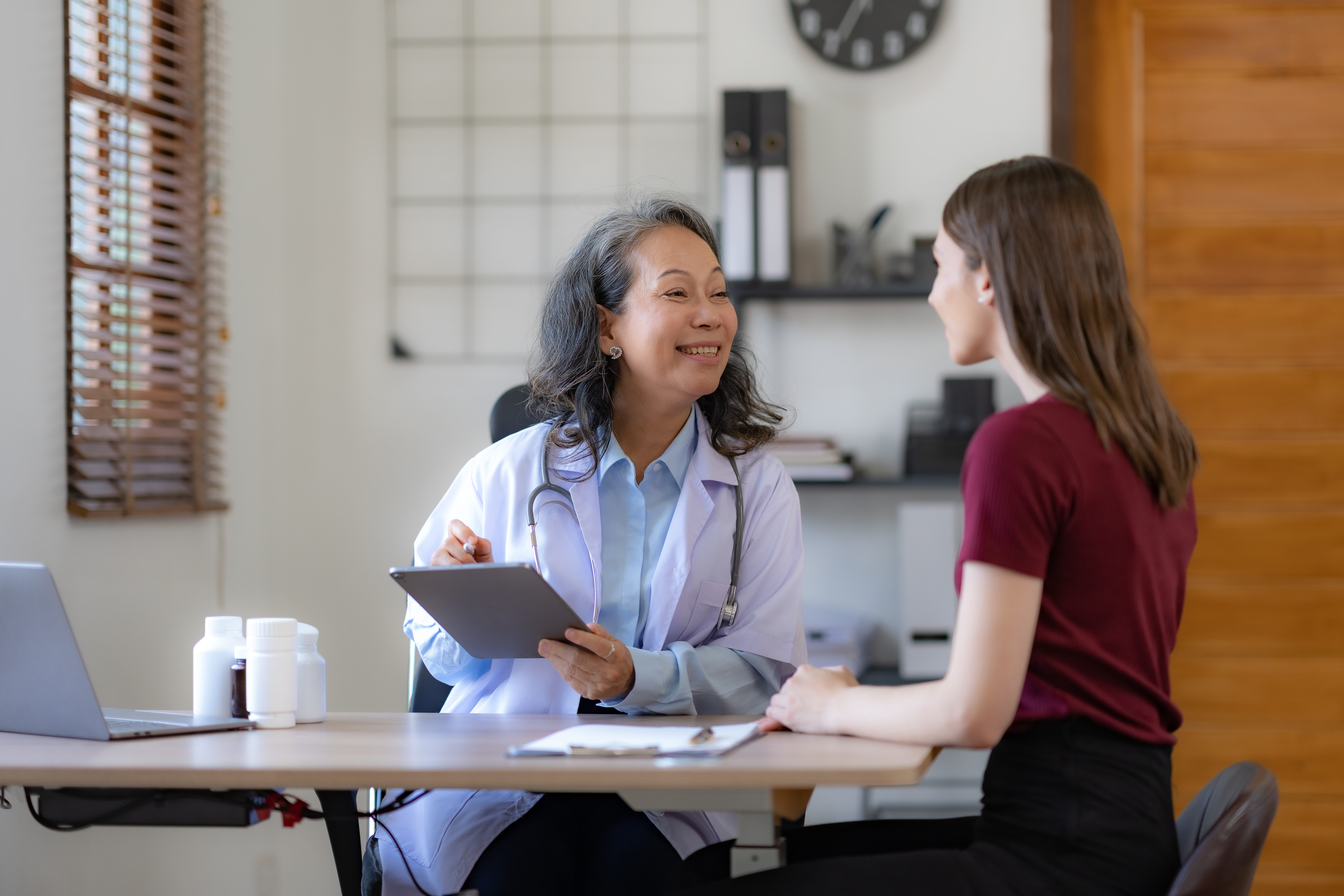 a woman in a pink dress pushing a pink walker