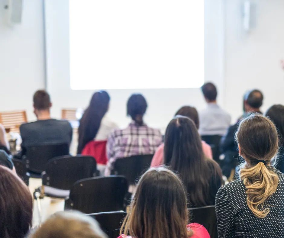 A yellow truck driving on top of a race track