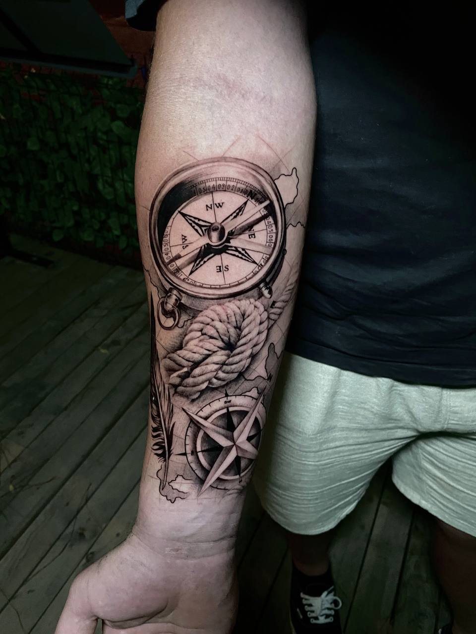 person in blue denim shorts and white nike sneakers standing on gray concrete floor