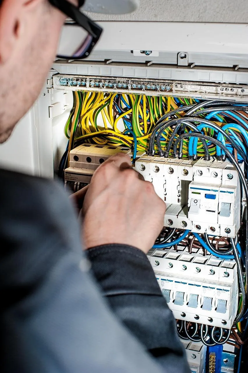 Electrician repairing electric board