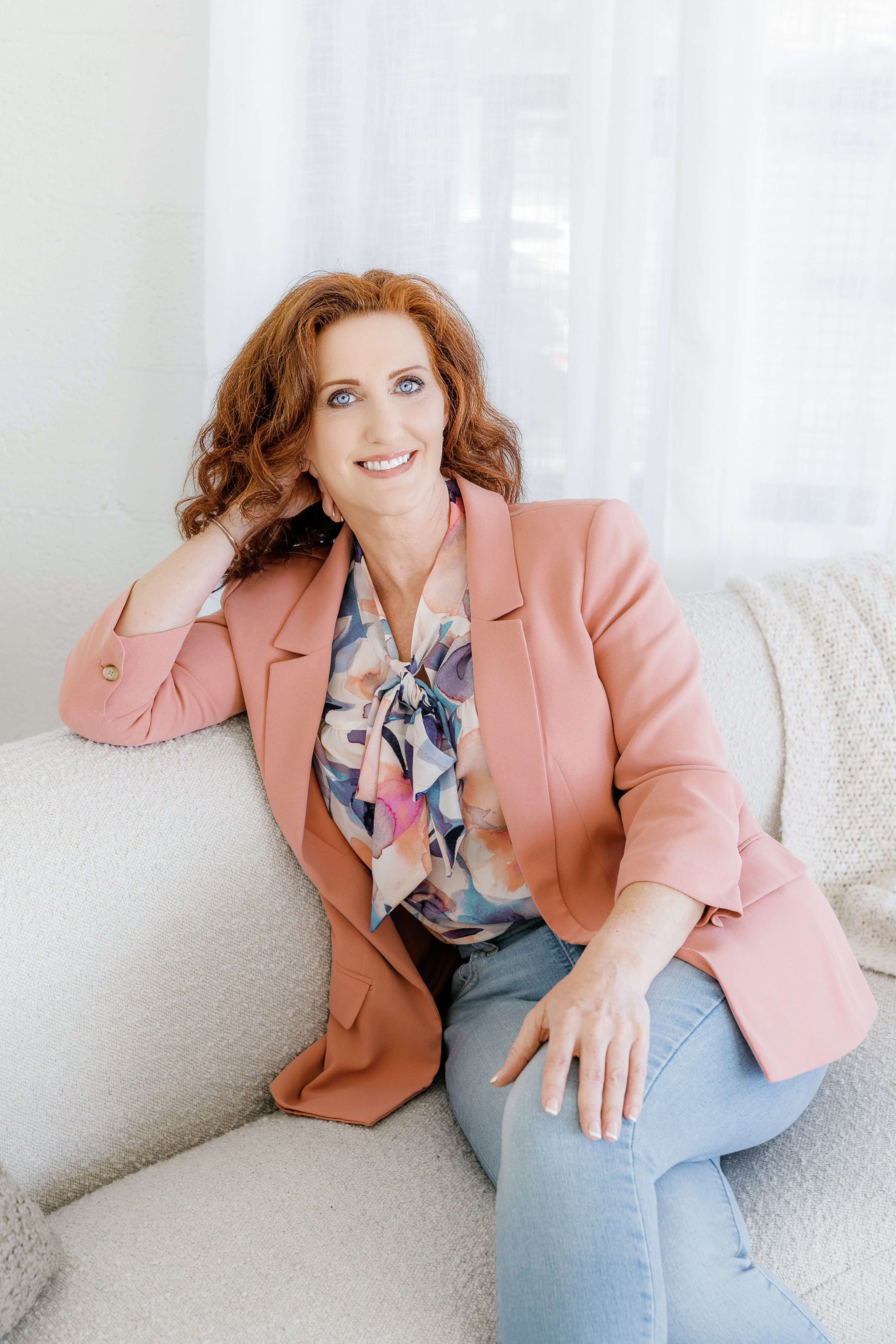 Heather Hickson smiling in a soft floral blouse, representing warmth, authenticity, and soulful guidance.