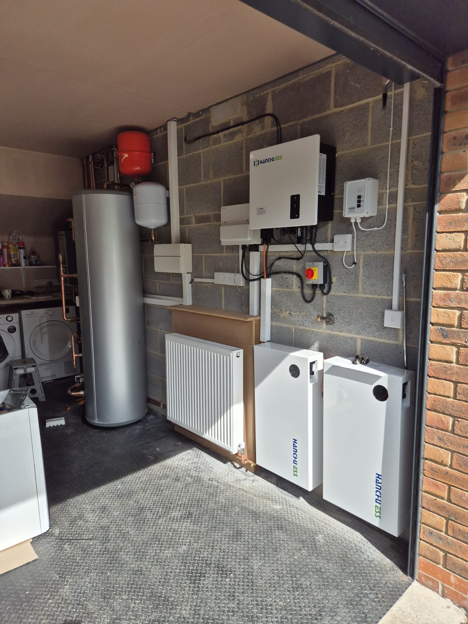 Modern UK home with solar panels, battery storage, and EV charging. A GE National smart energy system