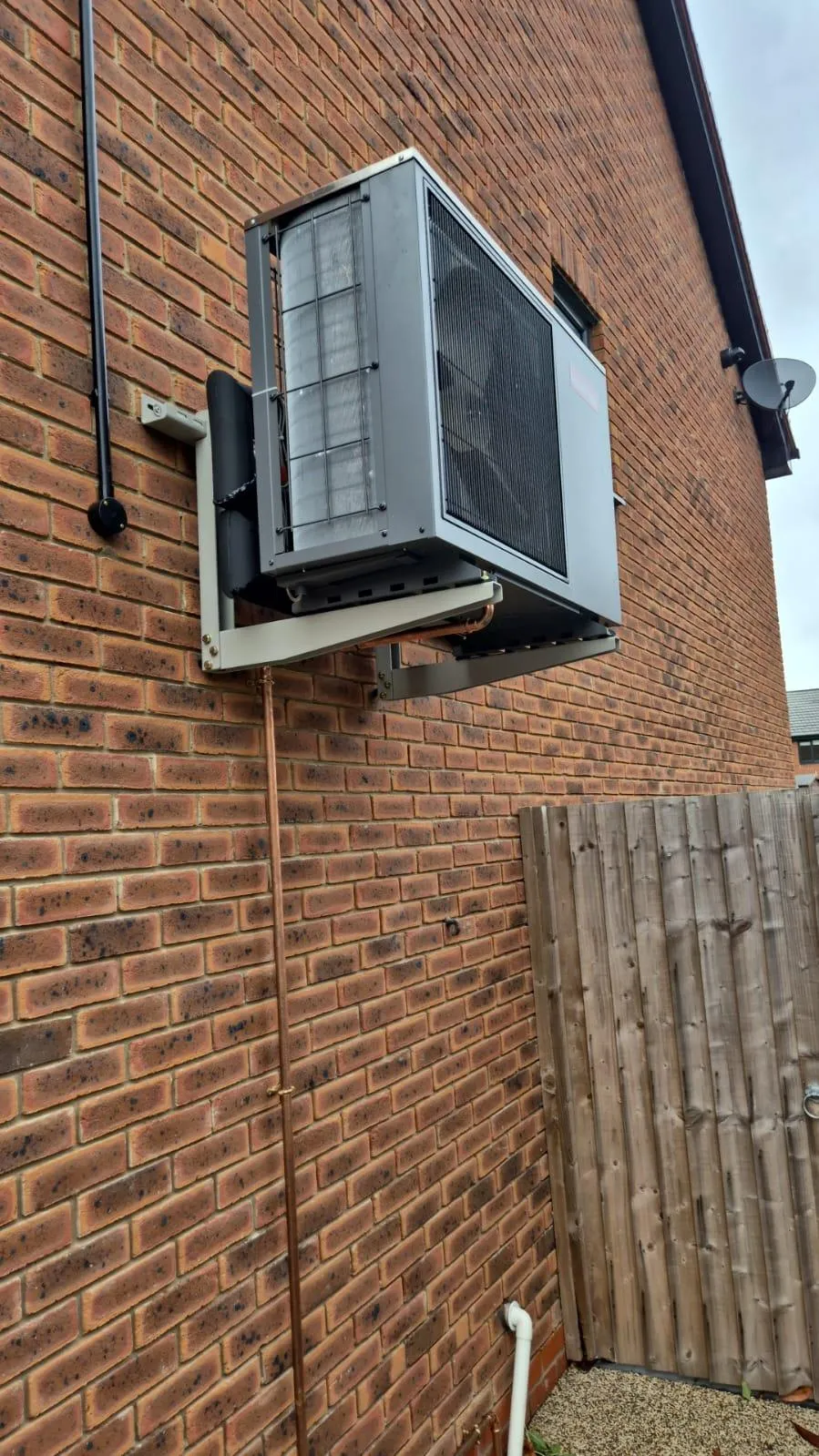 Modern UK home with solar panels, battery storage, and EV charging. A GE National smart energy system