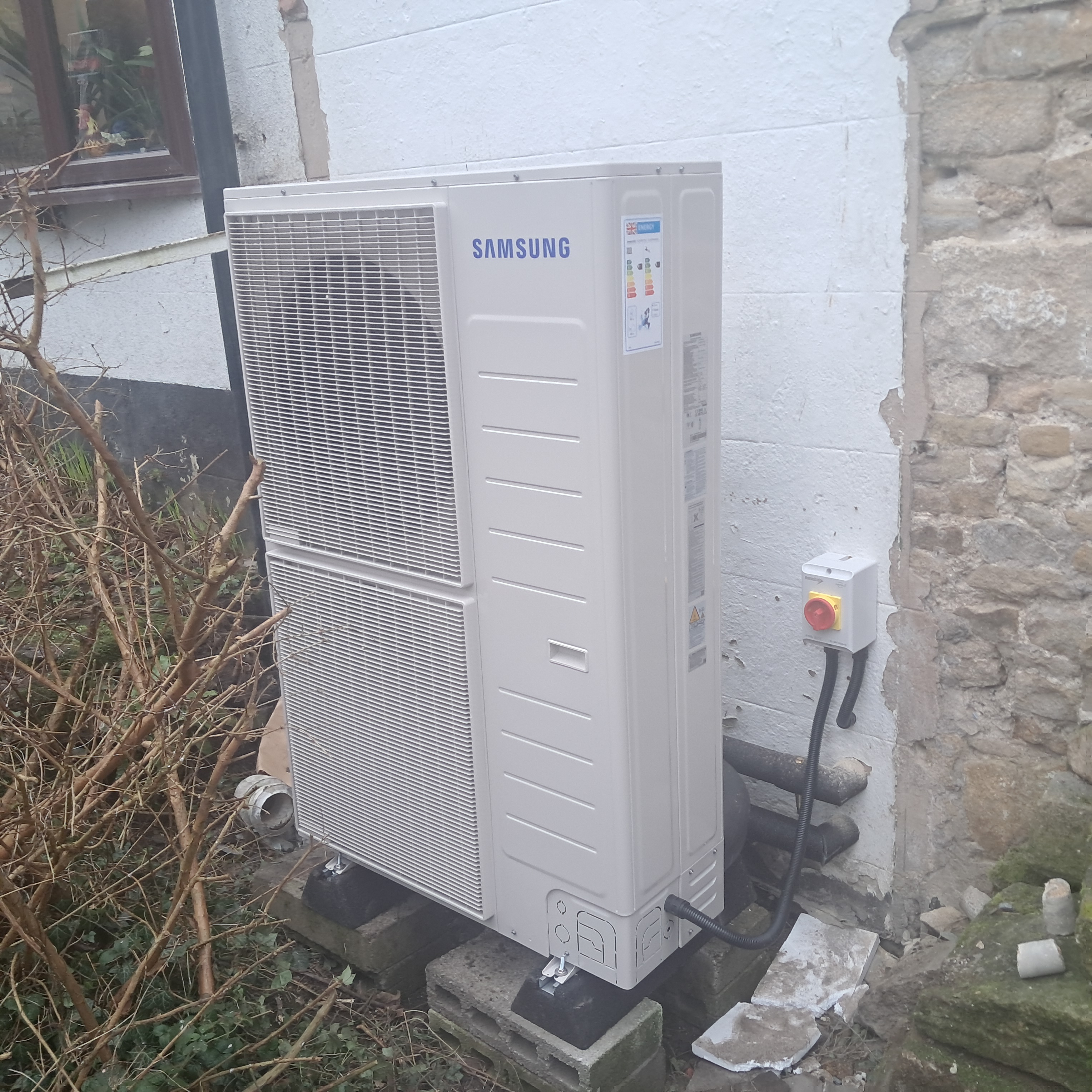 Modern UK home with solar panels, battery storage, and EV charging. A GE National smart energy system