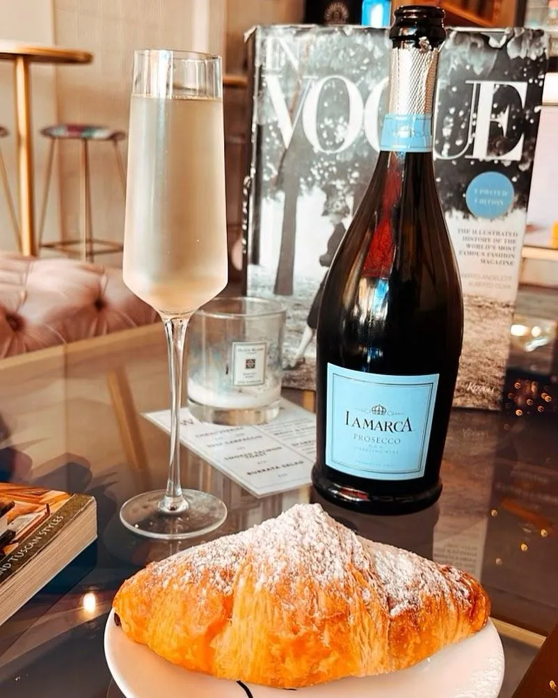 Croissant and bottle of wine and Cafe Renis