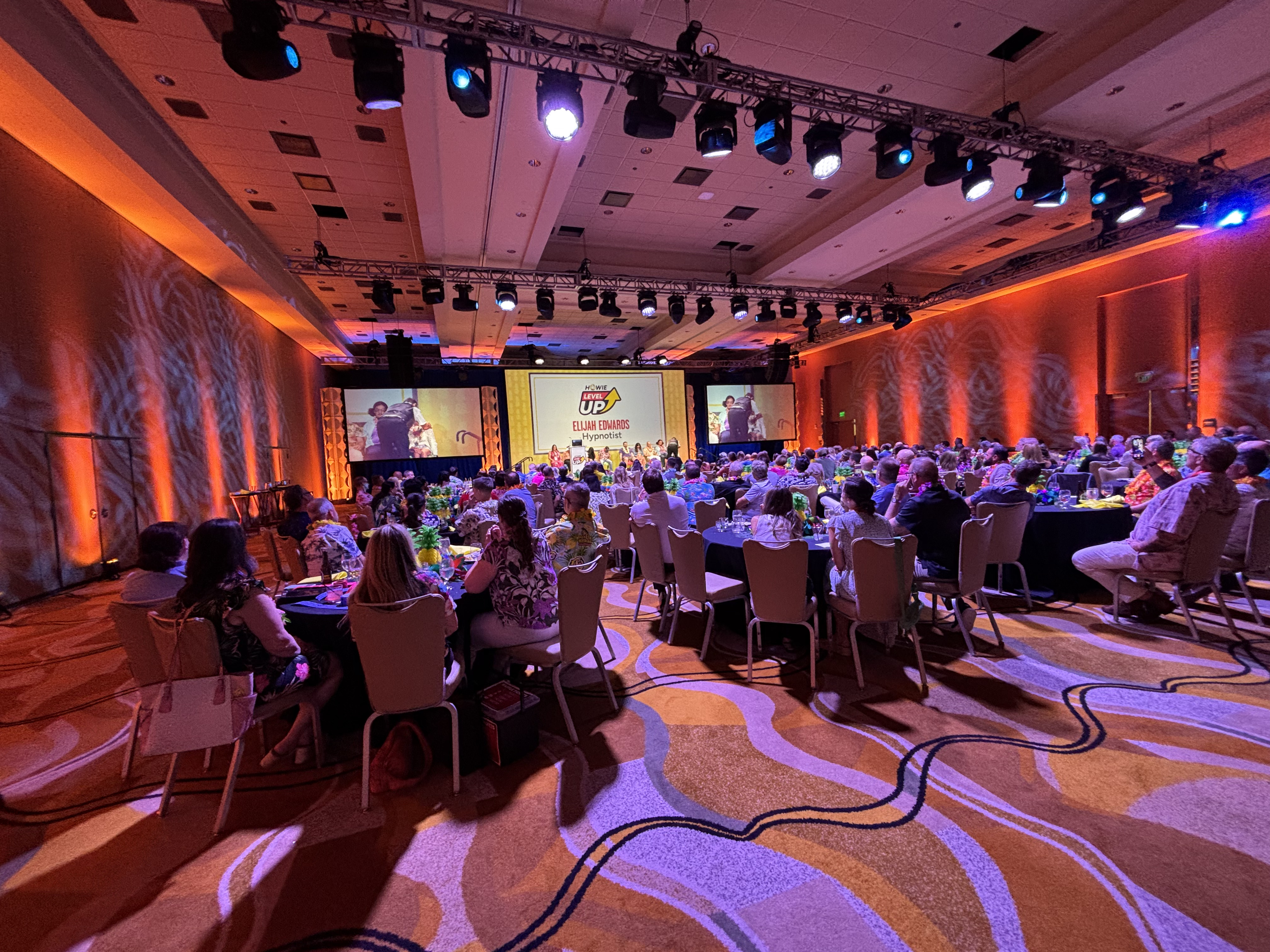 Elijah Edwards performing on stage in the MGM Grand ballroom during a live corporate event