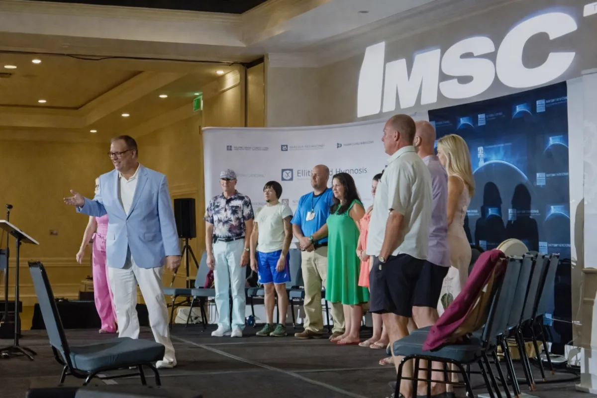 Elijah Edwards performing on stage inside a cruise ship gala grand ballroom during a live event