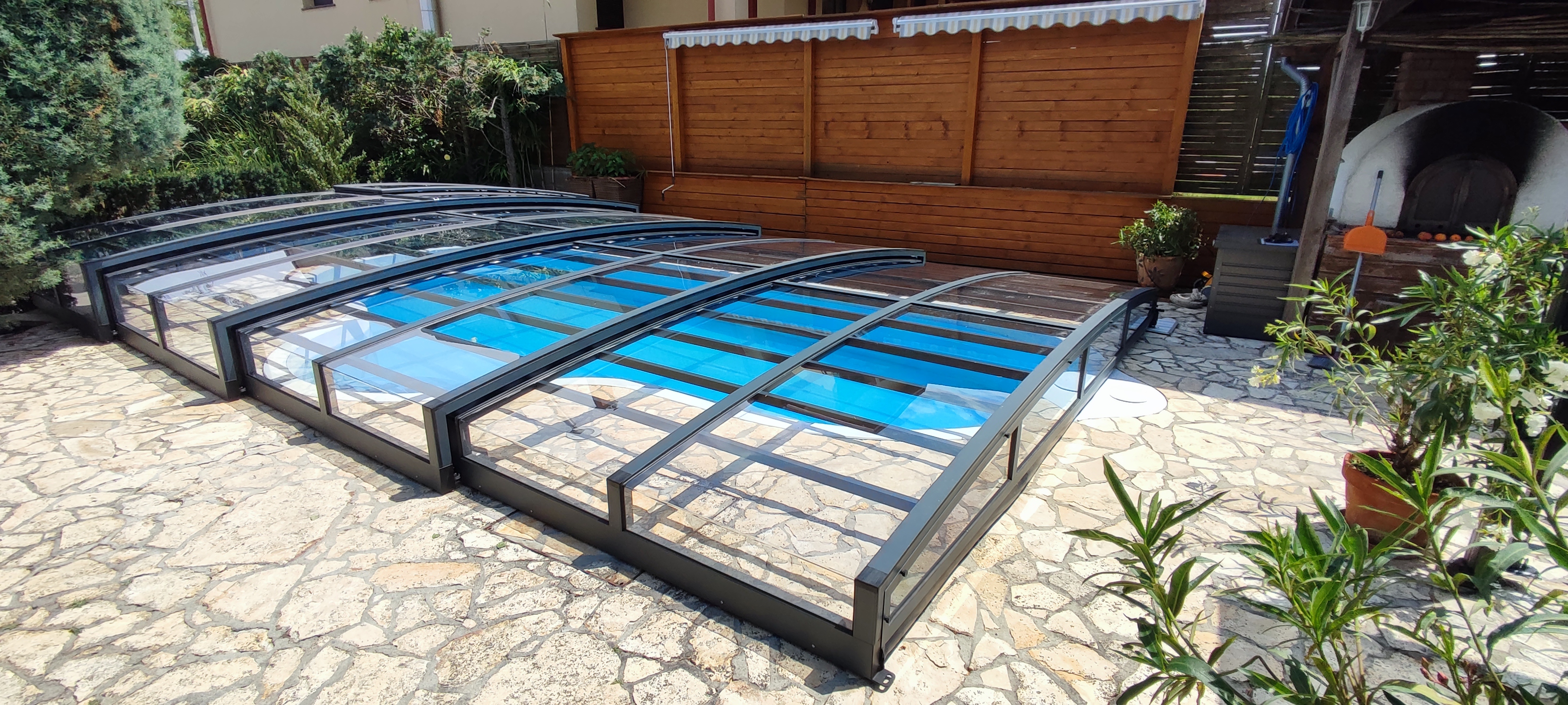 A white lotus flower blooms surrounded by green leaves.