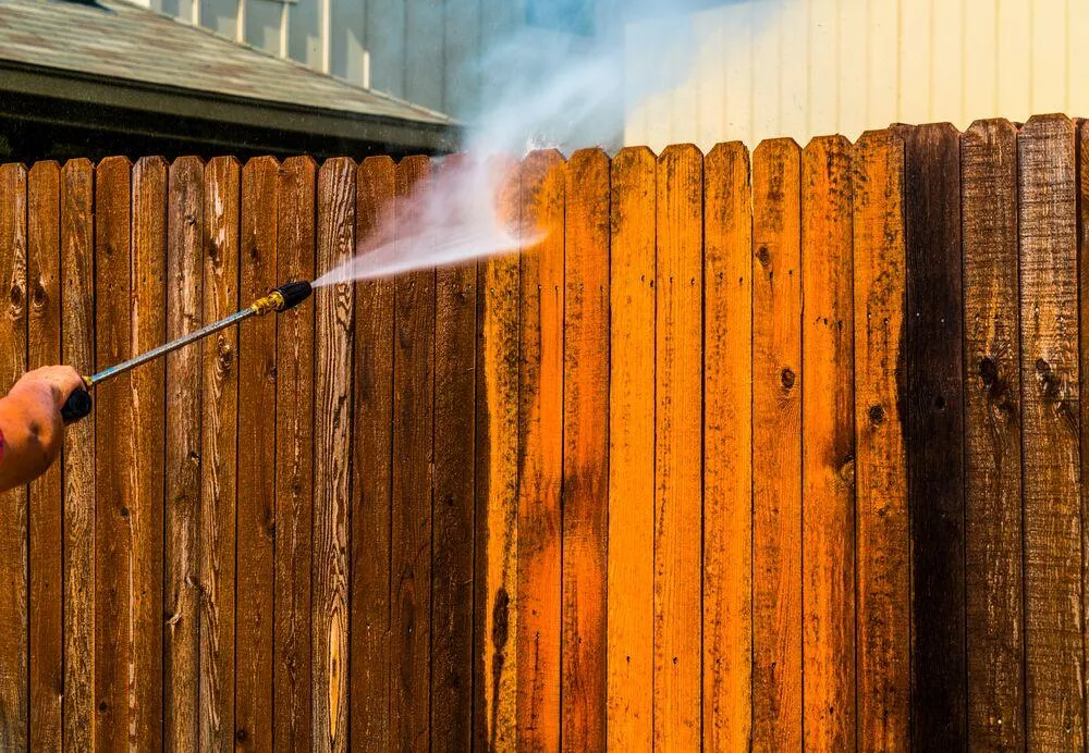 soft washing the fence to remove grime and dirt