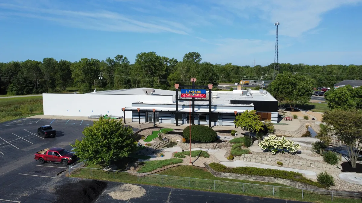 Rowboat on a wooden dock by a misty lake.