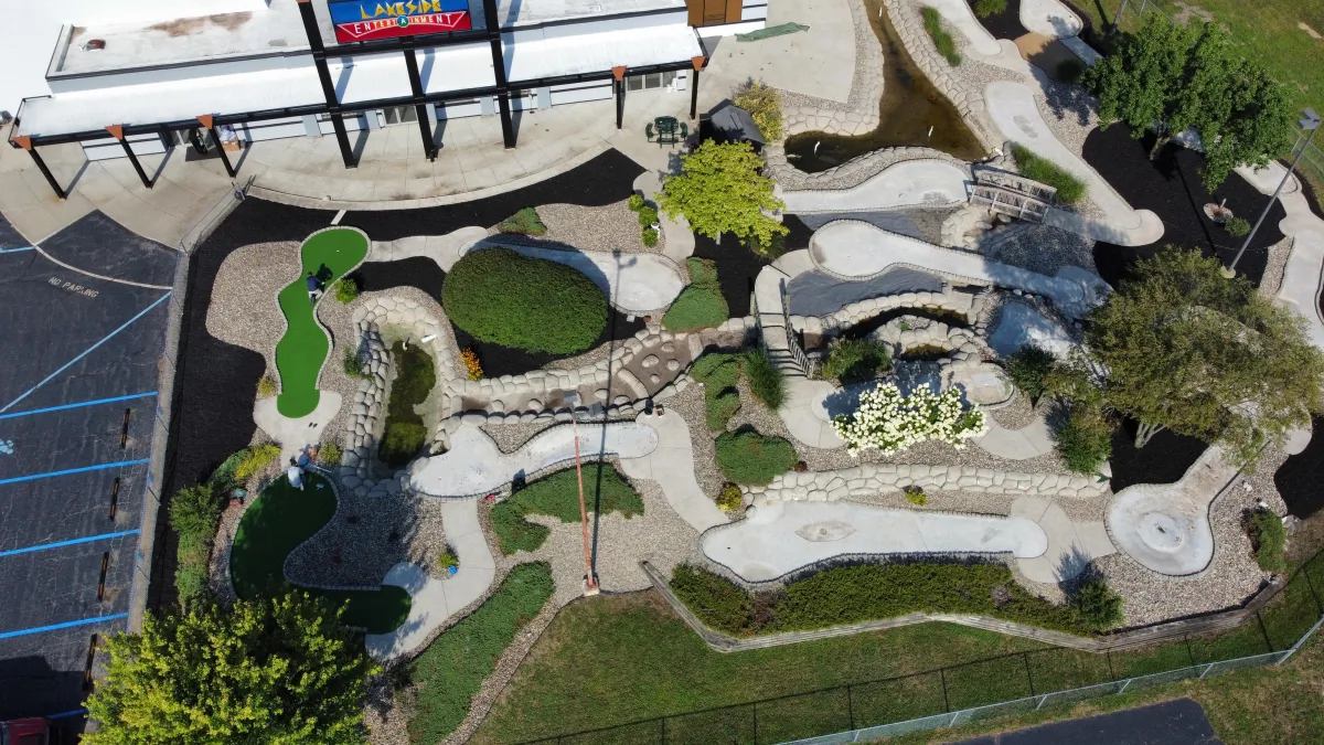 girl in white knit tank top standing on concrete pathway during daytime