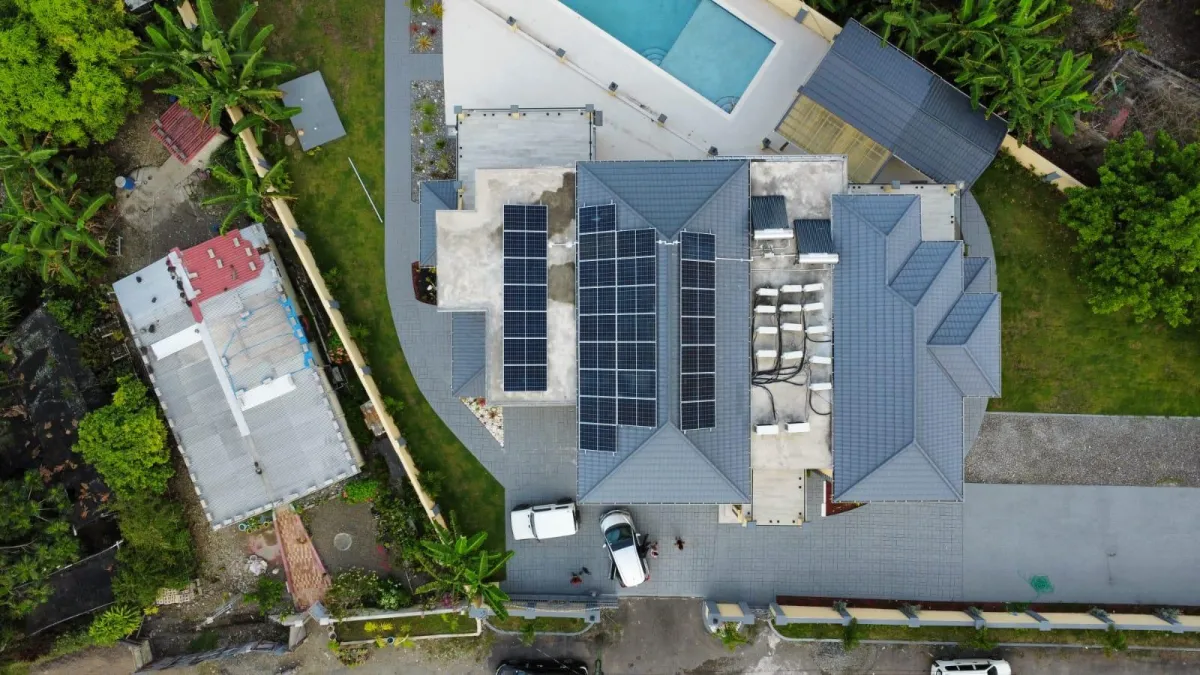 black solar panels on green grass field during daytime