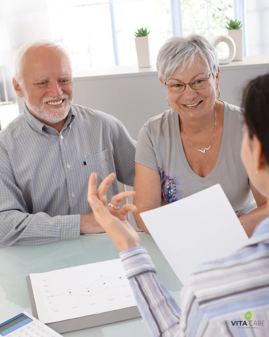 MacBook Air beside gold-colored study lamp and spiral books