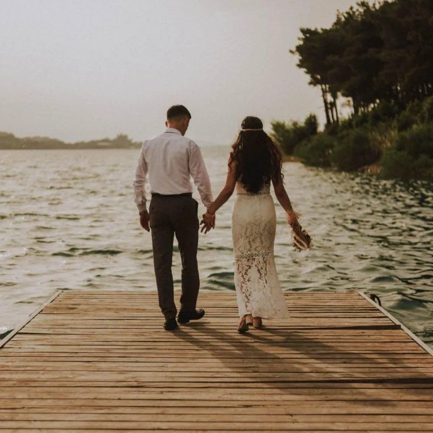 A photo of a couple standing together in a lake