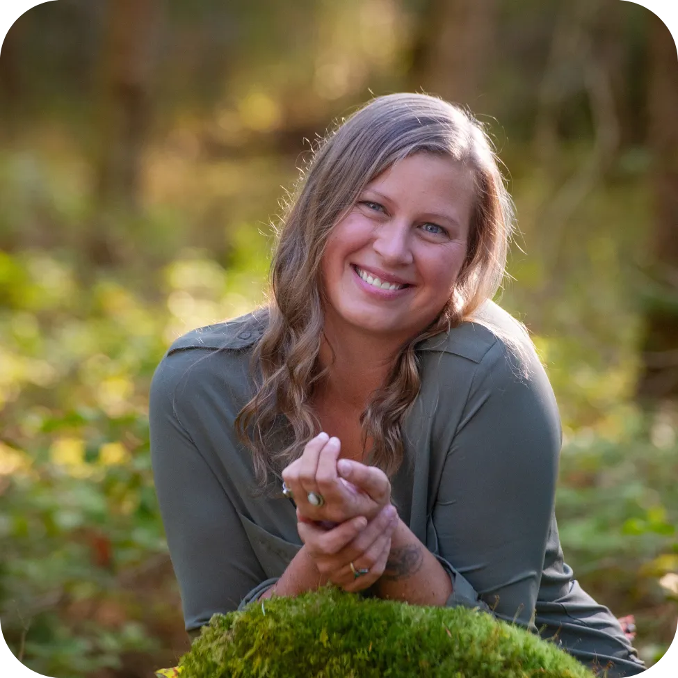 woman squatting in grass