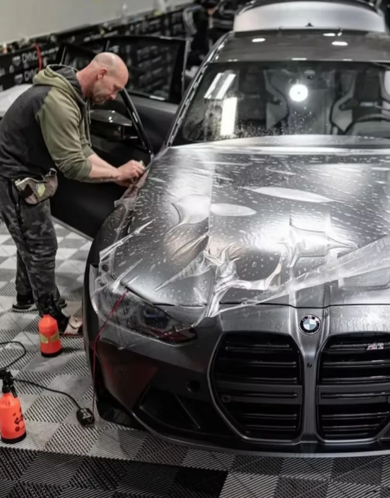 Man applying wrap on the car
