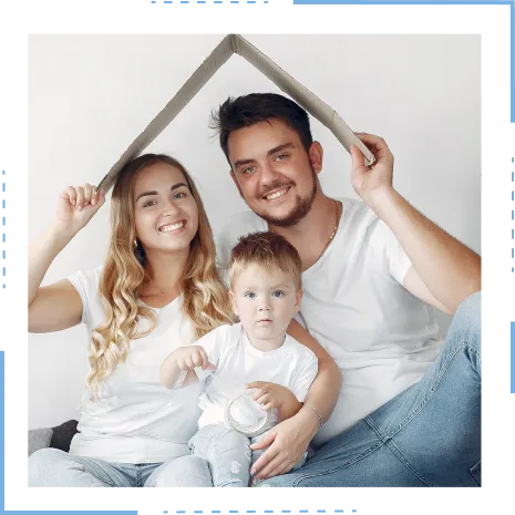  A happy family of three, under a cardboard roof, embodies the dream of owning seller financing homes.