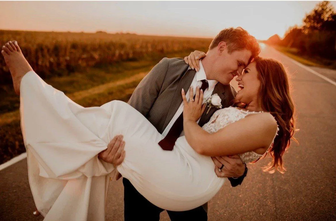 husband holding bride