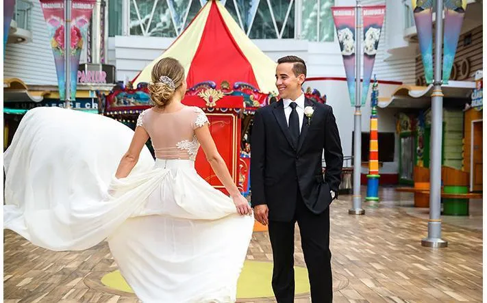 A wedding couple dancing on the boardwalk neighborhood of the cruise ship