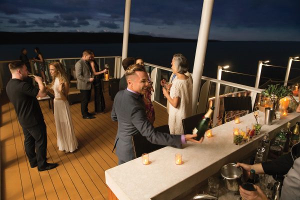 A small party on large suite balcony of a cruise ship.