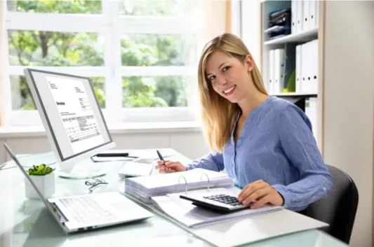 Professional bookkeeper reviewing documents with a smile