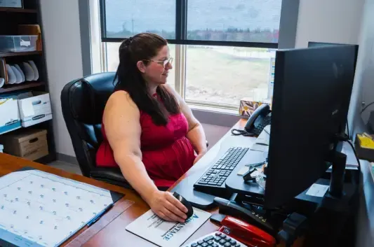 Professional bookkeeper reviewing documents with a smile