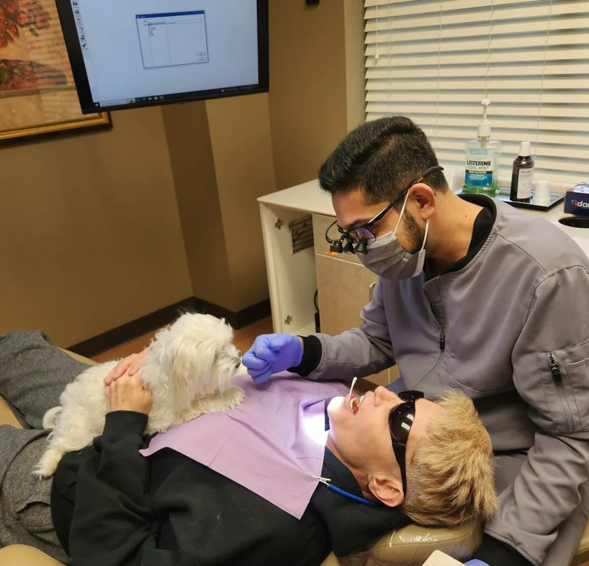 a young boy getting his teeth checked by a dentist