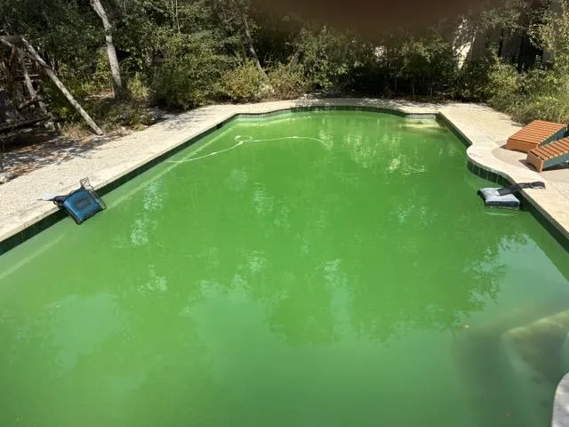 Cloudy greenish pool water before CYA correction