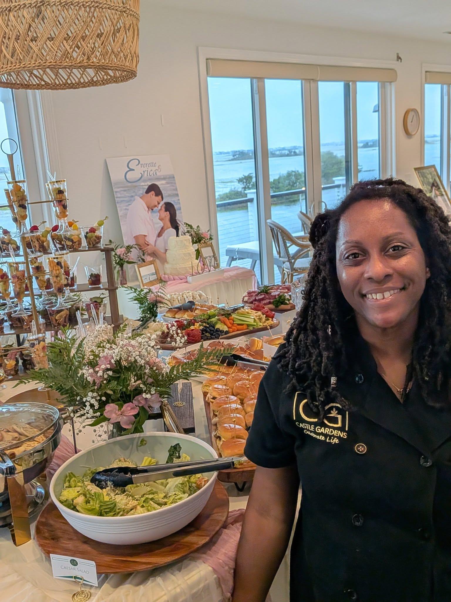 Catering display featuring croissant sandwiches filled with chicken salad, garnished with decorative toothpicks, and accompanied by assorted sliders, charcuterie, and fresh fruit cups, showcasing Castle Gardens ILM's elevated culinary offerings for events.