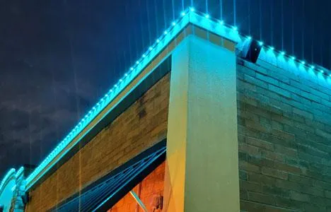 Permanent commercial lighting highlighting the exterior of a local business