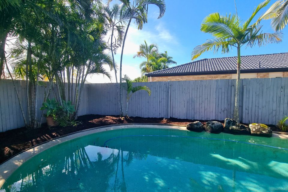 Clean and tidy backyard garden with reduced debris near pool