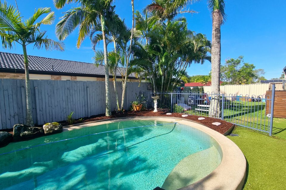 Poolside garden after clean-up with contained garden beds and tidy finish
