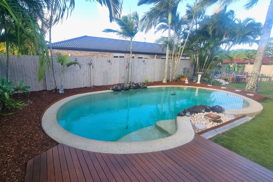 case study garden cleanup pool side with fresh mulch and stepping stones