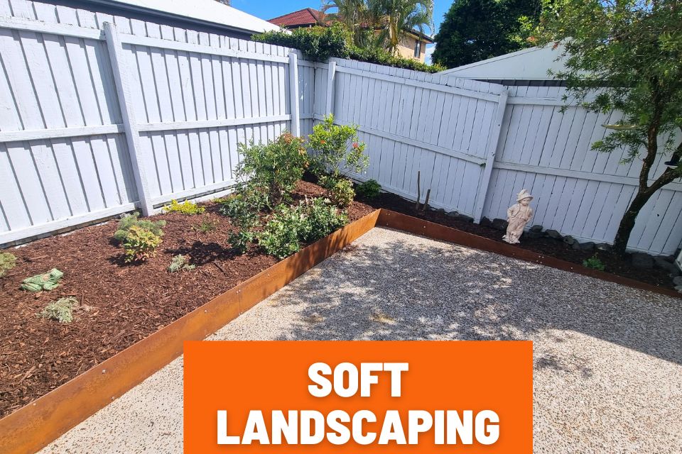 Low-maintenance garden after soft landscaping in Buderim with rust-look steel edging, pruned plants, weeded garden beds and fresh mulch