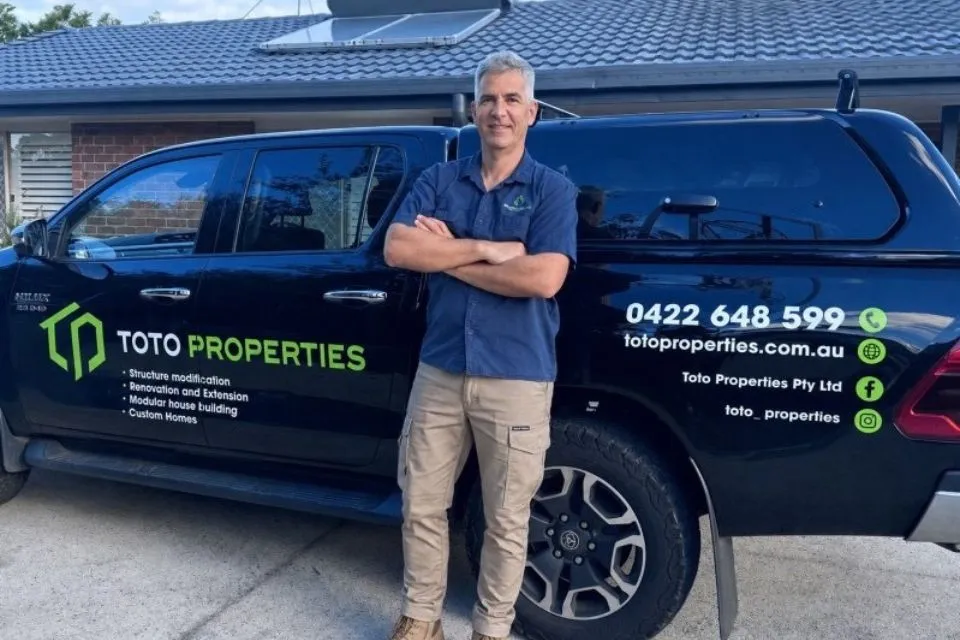 Licensed builder Peter standing in front of Toto Properties work vehicle