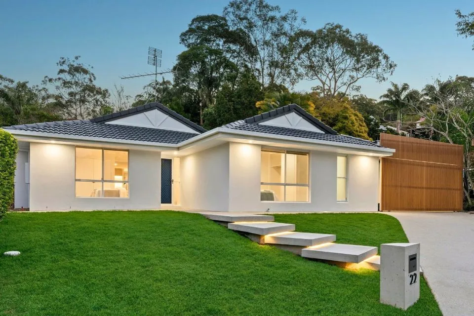 Low-set modern home extension and front yard lawn landscaping
