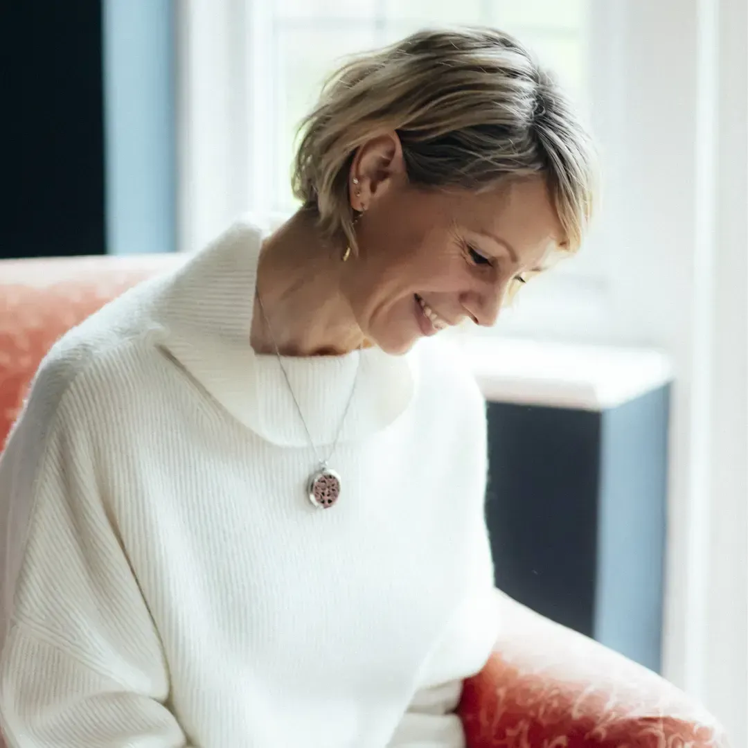 Kate seated looking down at a notebook on her lap